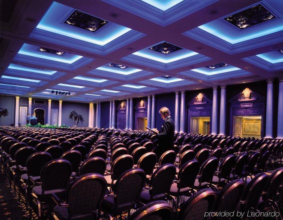 Hotel The Grand Hove Esterno foto The photo shows an interior space, likely a large conference or seminar room. It features rows of empty chairs arranged neatly in front of a stage or presentation area. The ceiling has a distinctive design with blue lighting that creates a vibrant at